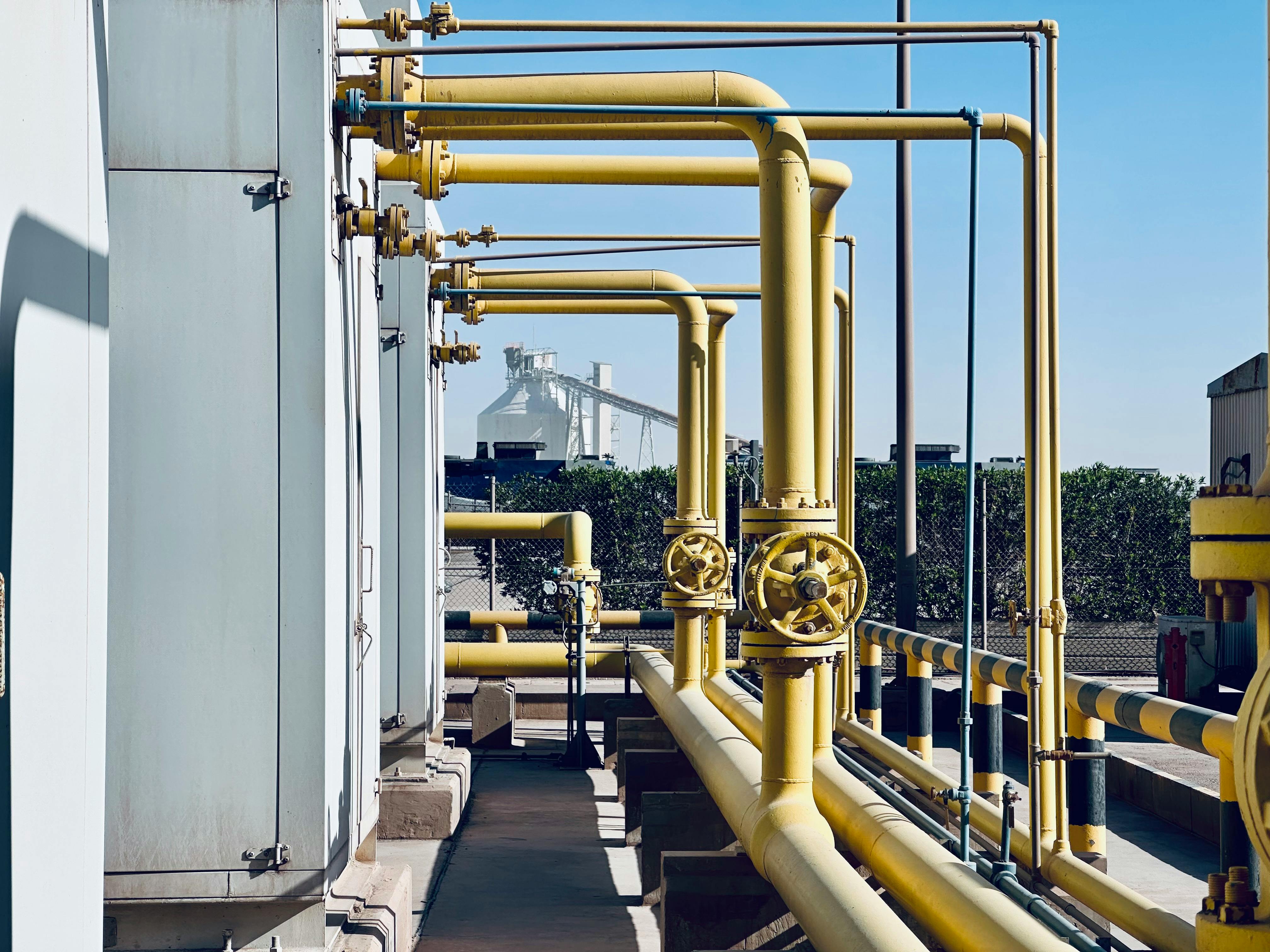 A detailed view of industrial pipelines in a Saudi Arabian factory setting.